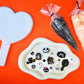Decorative items including a heart-shaped mirror and halloween charms and glue